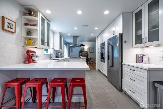 35717 321st St NE, Arlington, WA 98223 - kitchen with high end fridge, a sink, a peninsula, island exhaust hood, and recessed lighting