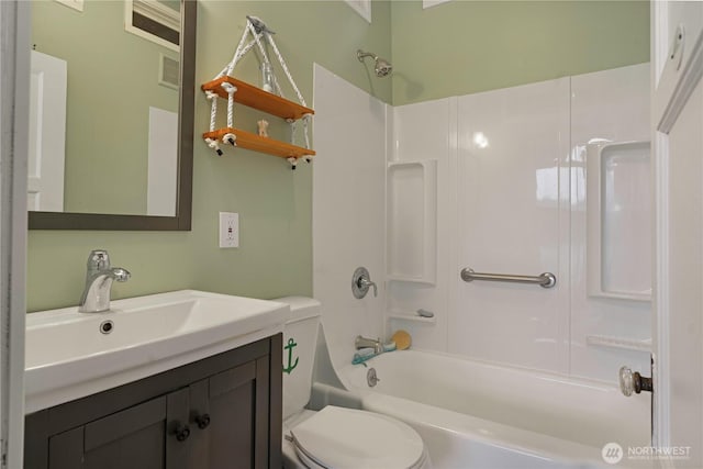 bathroom featuring toilet, shower / washtub combination, and vanity