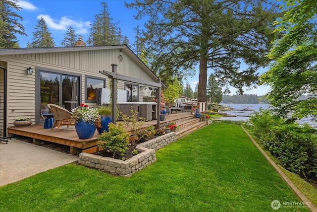 15208 W Lake Goodwin Rd, Stanwood, WA 98292 - rear view of house featuring a deck with water view, a chimney, and a yard