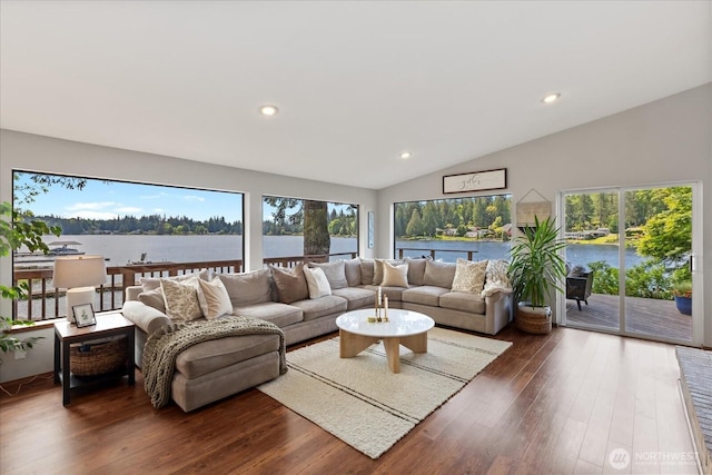 15208 W Lake Goodwin Rd, Stanwood, WA 98292 - living area featuring lofted ceiling, wood finished floors, recessed lighting, plenty of natural light, and a water view