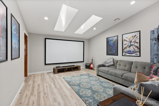 15208 W Lake Goodwin Rd, Stanwood, WA 98292 - home theater room featuring a skylight, lofted ceiling, wood finished floors, recessed lighting, and baseboards