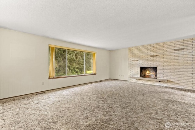 unfurnished living room with a textured ceiling, a fireplace, and carpet flooring