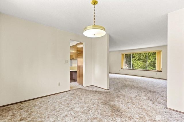 empty room with carpet flooring and baseboards