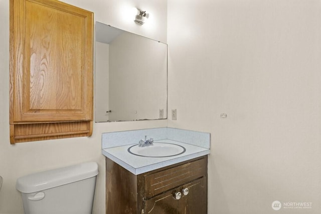 bathroom featuring vanity and toilet