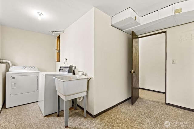 laundry area with separate washer and dryer, light colored carpet, and baseboards