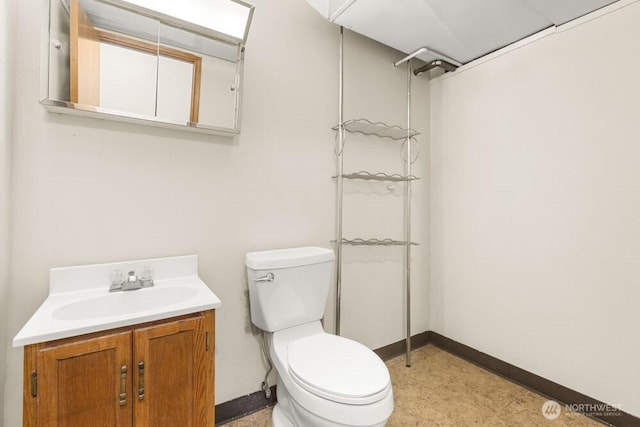 full bath featuring vanity, toilet, and baseboards