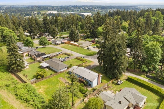 aerial view of residential area featuring a forest