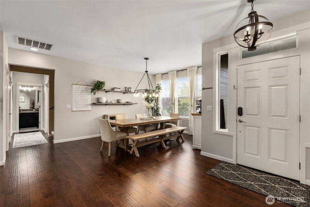 13708 Big Sky Dr E, Bonney Lake, WA 98391 - dining room featuring a chandelier, dark wood-style floors, and baseboards