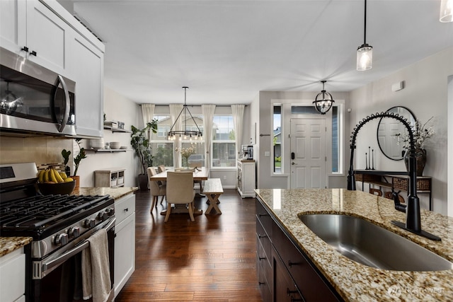 13708 Big Sky Dr E, Bonney Lake, WA 98391 - kitchen featuring stainless steel appliances, a sink, a chandelier, white cabinetry, and dark wood-style flooring