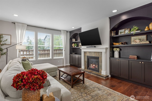 13708 Big Sky Dr E, Bonney Lake, WA 98391 - living area featuring dark wood finished floors, a fireplace, built in features, recessed lighting, and baseboards