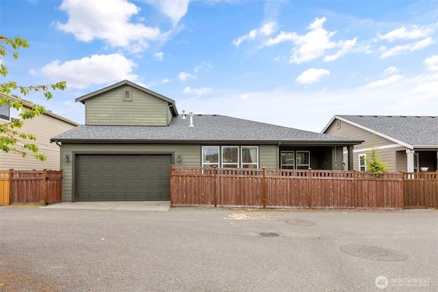 13708 Big Sky Dr E, Bonney Lake, WA 98391 - view of front facade featuring fence, a shingled roof, and driveway