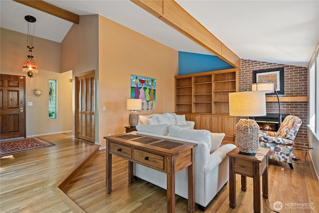3912 Sutherland St, Gig Harbor, WA 98332 - living area with wood finished floors, a brick fireplace, built in shelves, and baseboards