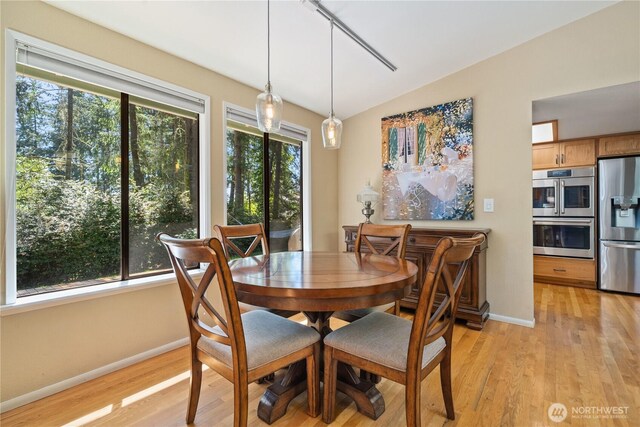 3912 Sutherland St, Gig Harbor, WA 98332 - dining room with healthy amount of natural light, light wood-style flooring, baseboards, and vaulted ceiling