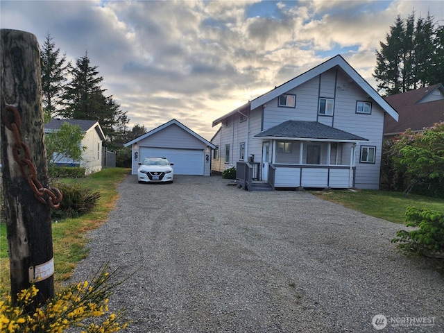 view of front facade featuring an outbuilding and a detached garage