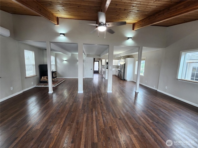 below grade area featuring ceiling fan, baseboards, dark wood-style flooring, and a wall unit AC