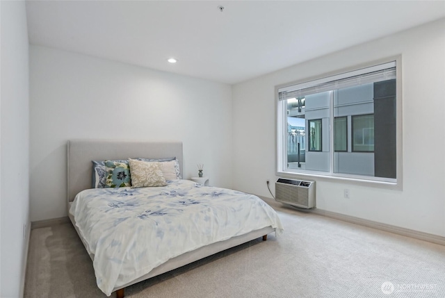 bedroom with an AC wall unit, carpet flooring, baseboards, and recessed lighting