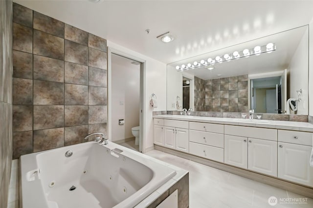 bathroom with toilet, a whirlpool tub, double vanity, and tile patterned floors