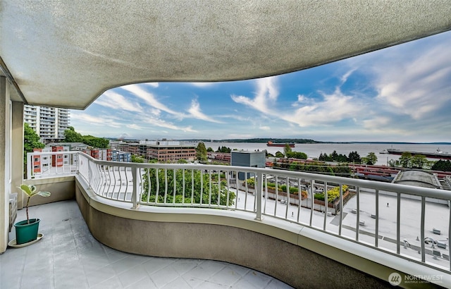 balcony with a water view and a city view