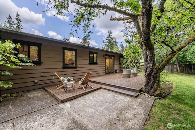 rear view of property featuring a deck and a patio