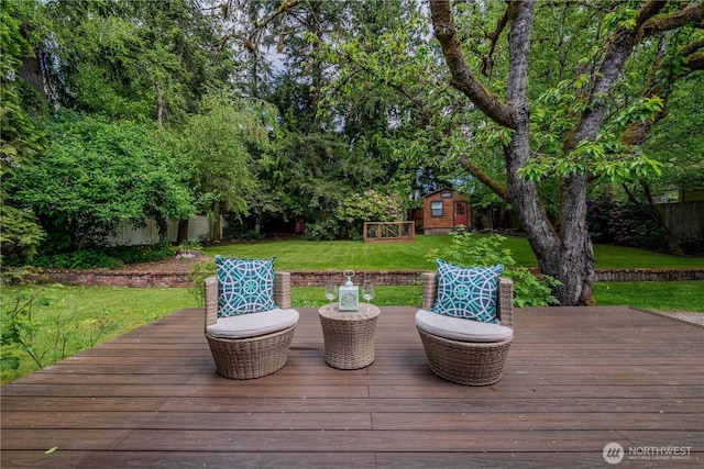 wooden deck with an outbuilding and a yard