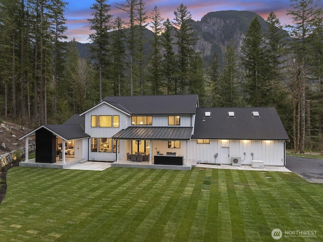 6993 N Fork Rd SE, Snoqualmie, WA 98065 - rear view of property with an outdoor living space, board and batten siding, a patio, a standing seam roof, and metal roof