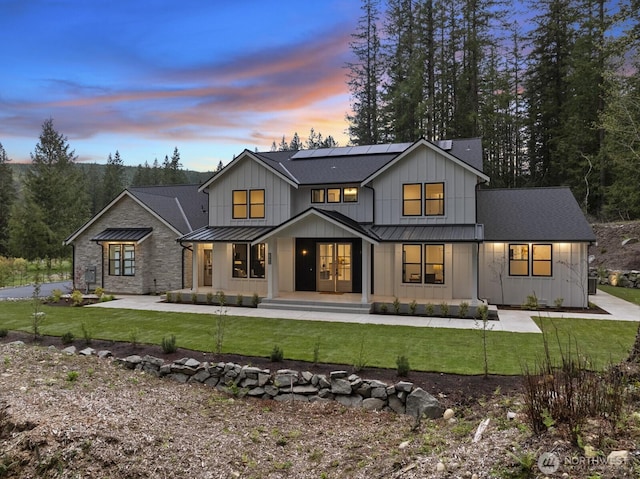 6993 N Fork Rd SE, Snoqualmie, WA 98065 - back of house featuring a standing seam roof, a porch, board and batten siding, and metal roof