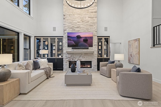 6993 N Fork Rd SE, Snoqualmie, WA 98065 - living room with a towering ceiling, a fireplace, wood finished floors, and baseboards
