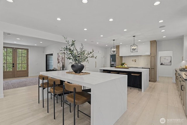 6993 N Fork Rd SE, Snoqualmie, WA 98065 - kitchen with a large island, recessed lighting, light wood-style flooring, tasteful backsplash, and light countertops