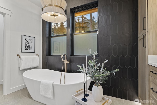 6993 N Fork Rd SE, Snoqualmie, WA 98065 - full bath with a freestanding tub, baseboards, vanity, tile patterned floors, and a tile shower