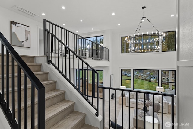 6993 N Fork Rd SE, Snoqualmie, WA 98065 - stairs with a chandelier, recessed lighting, and a towering ceiling
