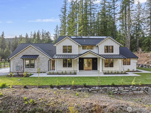 6993 N Fork Rd SE, Snoqualmie, WA 98065 - modern inspired farmhouse featuring a standing seam roof, roof mounted solar panels, and metal roof