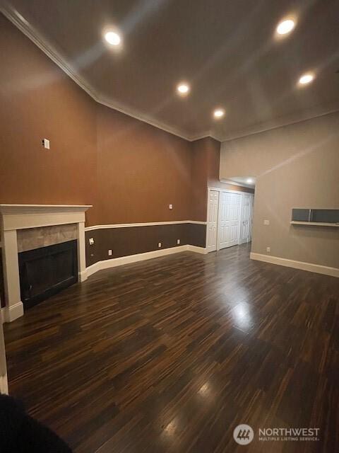 11717 93rd Ave NE Unit A7, Kirkland, WA 98034 - unfurnished living room with baseboards, crown molding, dark wood-type flooring, recessed lighting, and a fireplace