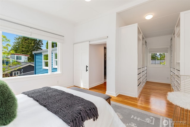 bedroom featuring light wood-type flooring and baseboards