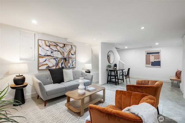 living area featuring recessed lighting, baseboards, and concrete floors