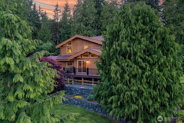 7353 Cedar House Ct, Clinton, WA 98236 - back of property at dusk featuring a deck and a yard