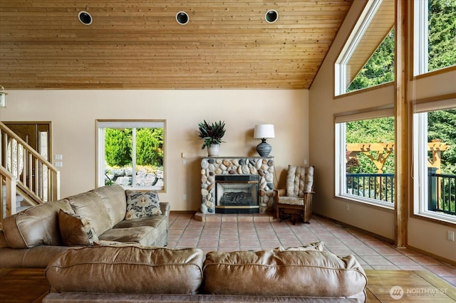 7353 Cedar House Ct, Clinton, WA 98236 - living area with wood ceiling, tile patterned floors, stairs, a fireplace, and baseboards