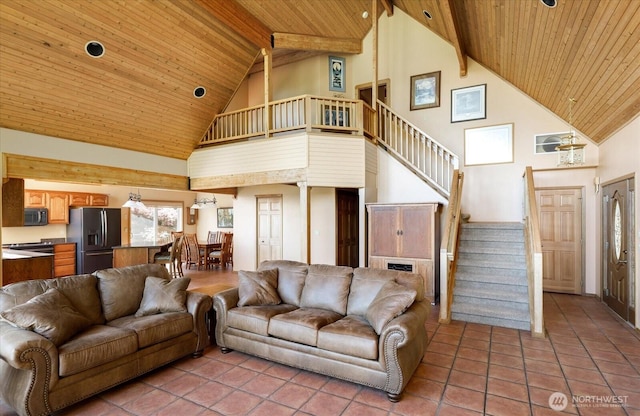 7353 Cedar House Ct, Clinton, WA 98236 - living room featuring high vaulted ceiling, wooden ceiling, stairs, light tile patterned floors, and beam ceiling