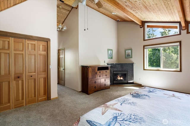 7353 Cedar House Ct, Clinton, WA 98236 - bedroom featuring wood ceiling, carpet floors, high vaulted ceiling, beam ceiling, and a fireplace