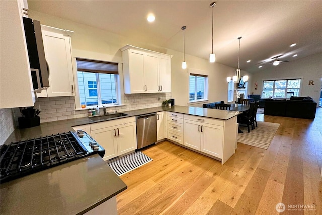 81 E Sullivan St, Allyn, WA 98524 - kitchen with stainless steel dishwasher, open floor plan, a sink, light wood-type flooring, and ceiling fan