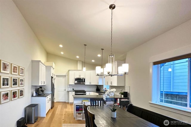 81 E Sullivan St, Allyn, WA 98524 - dining area with recessed lighting, light wood-type flooring, a chandelier, and lofted ceiling