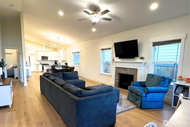 81 E Sullivan St, Allyn, WA 98524 - living room with lofted ceiling, a ceiling fan, light wood finished floors, recessed lighting, and a brick fireplace