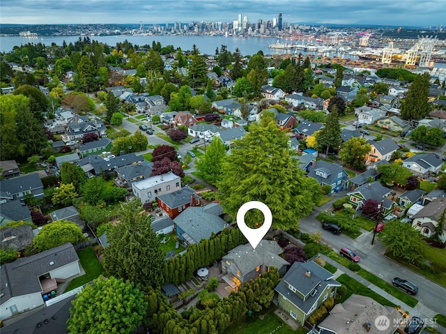 aerial overview of property's location with a nearby body of water and nearby suburban area