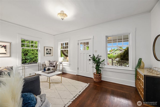 living room featuring healthy amount of natural light, ornamental molding, dark wood finished floors, and baseboards