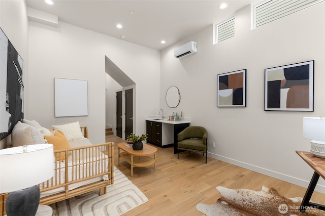 1108B 34th Ave, Seattle, WA 98122 - sitting room featuring a wall mounted air conditioner, light wood-style flooring, and recessed lighting