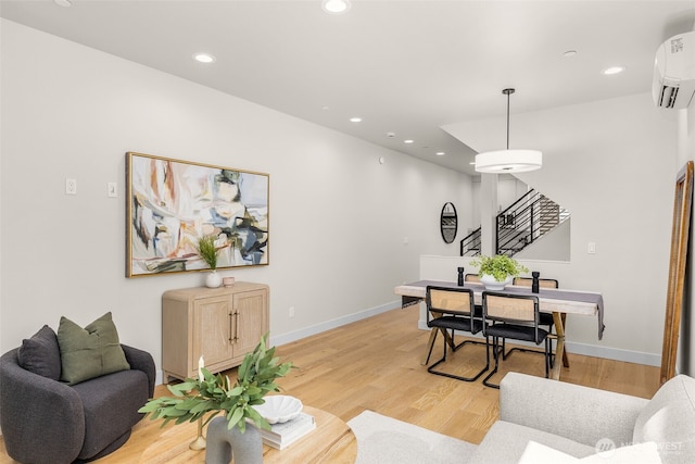 1108B 34th Ave, Seattle, WA 98122 - living room featuring an AC wall unit, light wood-style floors, and recessed lighting