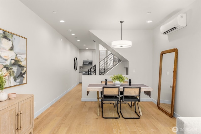 1108B 34th Ave, Seattle, WA 98122 - dining room with a wall mounted air conditioner, light wood-type flooring, stairway, and recessed lighting