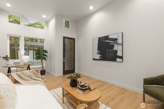 1108B 34th Ave, Seattle, WA 98122 - living room with light wood-style flooring, recessed lighting, a towering ceiling, and baseboards