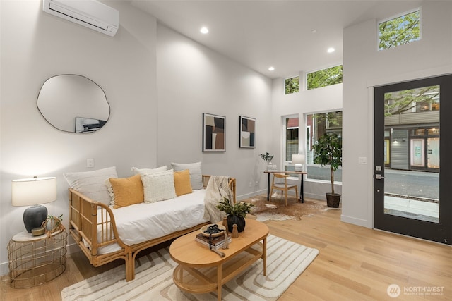 1108B 34th Ave, Seattle, WA 98122 - living room featuring a wall mounted AC, light wood finished floors, a towering ceiling, recessed lighting, and baseboards