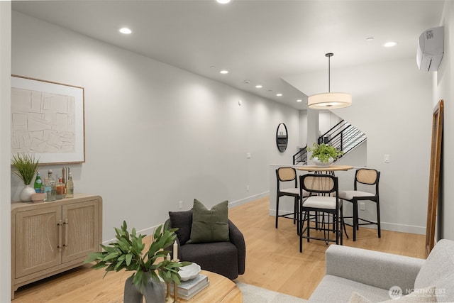 1108B 34th Ave, Seattle, WA 98122 - living area with recessed lighting, a wall mounted AC, light wood-style flooring, and baseboards