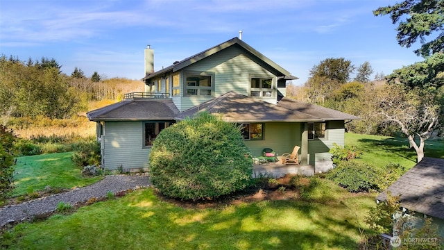 2333 Tuttle Ln, Lummi Island, WA 98262 - back of house with a chimney, a yard, and a balcony